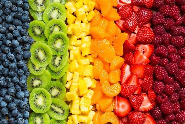 Different fruit organized to look like a rainbow
